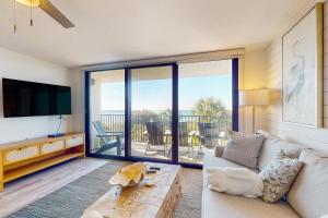 a living room with a couch and a view of the ocean at One Seagrove Place 0206 in Santa Rosa Beach