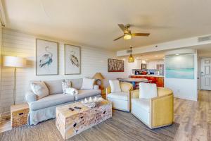 a living room with a couch and a table at One Seagrove Place 0206 in Santa Rosa Beach
