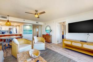 a living room with a large flat screen tv at One Seagrove Place 0206 in Santa Rosa Beach