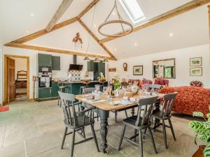a dining room and living room with a table and chairs at Loch Farm Stables in Watton