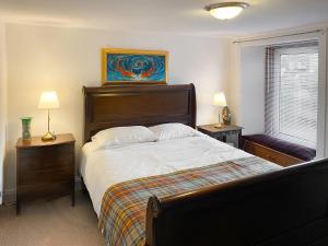 a bedroom with a large bed and two night stands at The Thistle in Auchtermuchty