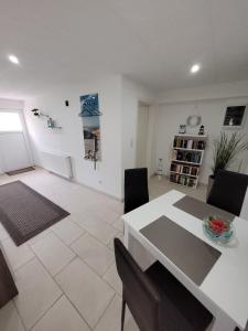 een woonkamer met een witte tafel en stoelen bij Ferienwohnung 1 - a72143 in Wangerland