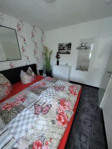 a bedroom with a bed with a butterfly quilt at Ferienwohnung 1 - a72143 in Wangerland