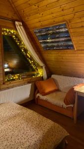 a room with two beds and a window with lights at Apartament Centrum Zakopane in Zakopane