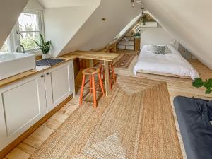 a kitchen with a sink and a bed in a attic at Hazel Nook in Trotton