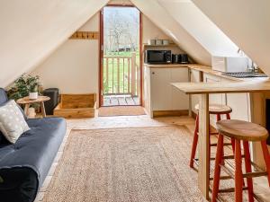 a living room with a couch and a table at Hazel Nook in Trotton