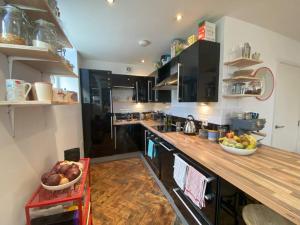 a kitchen with a counter with bowls of fruit on it at Biophilic Duplex - Family & Pet Friendly in Sheffield