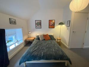 a bedroom with a large bed and a window at Biophilic Duplex - Family & Pet Friendly in Sheffield