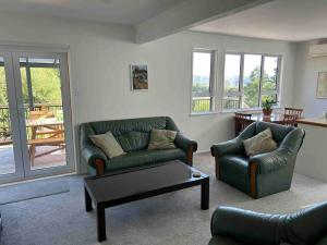 a living room with two couches and a coffee table at ‘The Don’ on Hillcrest in Wairoa