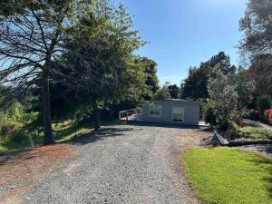 a house on the side of a gravel road at ‘The Don’ on Hillcrest in Wairoa