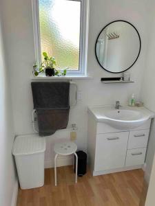 a small bathroom with a sink and a mirror at ‘The Don’ on Hillcrest in Wairoa