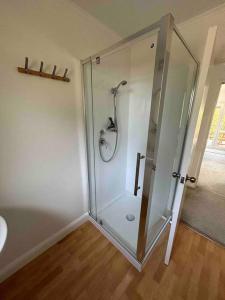 a bathroom with a shower with a glass door at ‘The Don’ on Hillcrest in Wairoa