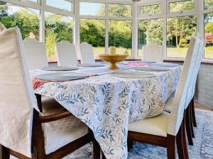 a dining room with a table and white chairs at Twegan in Trunch