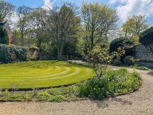 a garden with a grassy circle in the middle at Twegan in Trunch