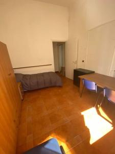 a room with a bed and a table in it at Sole Urbano in Messina