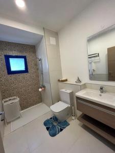 a bathroom with a toilet and a sink and a mirror at Marassi in El Alamein