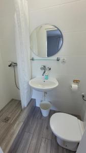 a bathroom with a toilet and a sink and a mirror at NIKA Pokoje u Weroniki in Władysławowo +44 photos