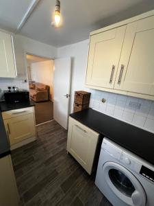 a kitchen with a washer and dryer in a room at Quite apartment in Nottingham