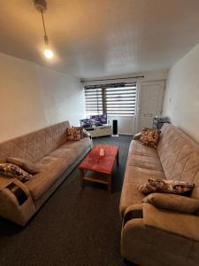 a living room with a couch and a table at Quite apartment in Nottingham