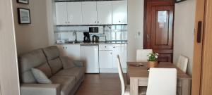 a living room with a couch and a kitchen at Apartamentos Don Pepe in Torremolinos