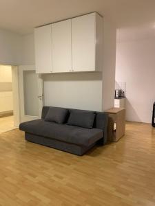 a living room with a couch and a kitchen at Ferienwohnung für kleine und große Reisegruppe in Dresden