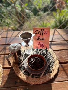 a sign that says coffee bar with a bowl of coffee beans at Adella's Blue Mountain Coffee Farmstay in Kingston