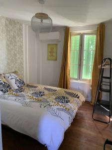 a bedroom with a bed and a ladder and a window at Le Pressoir Macy - Terracobois in Choussy