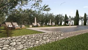 a pool with lounge chairs and a stone wall at Agriturismo Sole in Trequanda