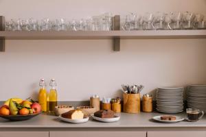 a kitchen with plates and bowls of food on a counter at Yelo Mozart powered by Sonder in Nice