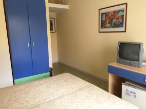 a bedroom with a television and a bed at Grand Hotel La Playa in Sperlonga