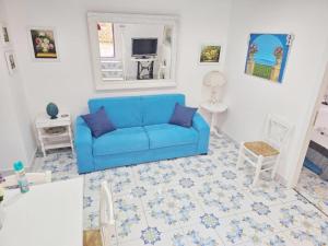 a living room with a blue couch and a mirror at Casa Tina indipendente a 2 passi dal centro al foro italico e al nuovo porto marina bay in Palermo