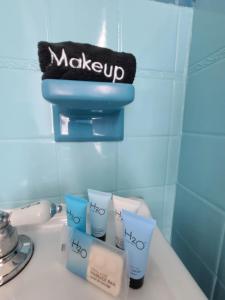 a bathroom sink with a pile of toiletries on it at Duval Street Suite w kitchen and shared heated pool in Key West
