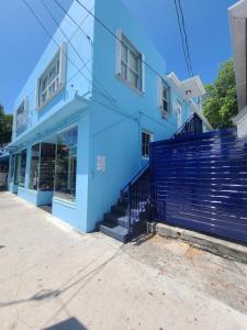 a blue building with stairs in front of a store at Duval Street Suite w kitchen and shared heated pool in Key West