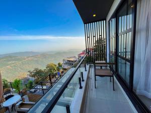 a balcony with chairs and a view of the mountains at Fiora Hotel in Murree