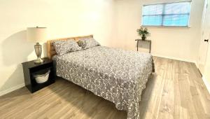 a bedroom with a bed and a lamp on a wooden floor at Private room Plano in Plano