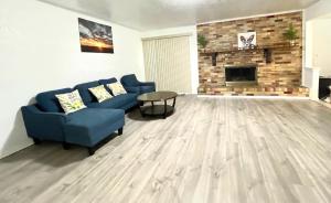 a living room with a blue couch and a fireplace at Private room Plano in Plano
