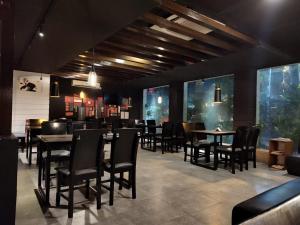 a dining room with tables and chairs in a restaurant at Swarloke Apartment at Gulshan 2,Dhaka in Dhaka