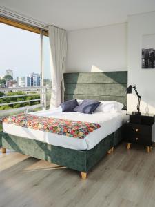 Un pat sau paturi într-o cameră la Apartamentos Mila Homes Armenia