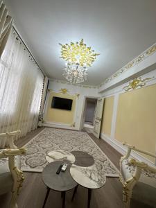 a living room with a chandelier and a table at Dushanbe Center in Dushanbe