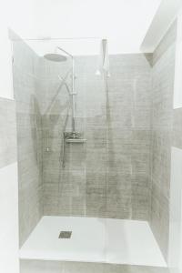 a shower with a glass door in a bathroom at B&B Art in Reggio Calabria