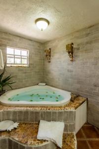 a bathroom with a jacuzzi tub in a room at The vintage charm in Cliftons