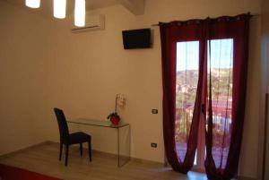 a room with a table and a chair and a window at Le Mulinare - Bed & Breakfast in Drapia