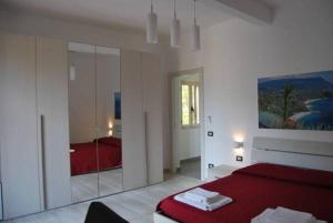 a bedroom with a red bed and a mirror at Le Mulinare - Bed & Breakfast in Drapia