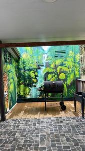 a wall with a mural of a jungle at MBS Studio LA CARAPA in Guenouillet