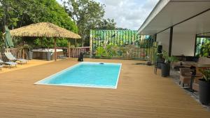 a swimming pool on a deck with a table and chairs at MBS Studio LA CARAPA in Guenouillet