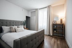 Un dormitorio con una cama grande y una ventana en Ruby 2 BR apt in MiracleMile, en Los Ángeles