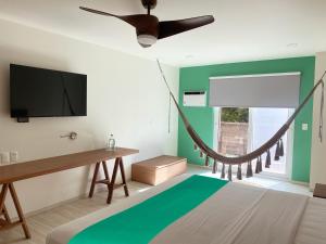 a bedroom with a hammock hanging from the wall at Siente Tulum in Tulum