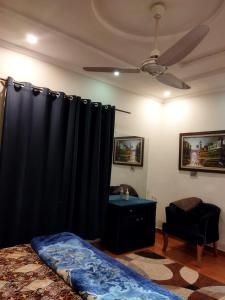 a bedroom with a bed and a black curtain at Tranquil apartments in Islamabad