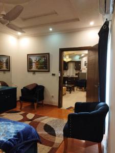 a living room with a bed and a living room with a mirror at Tranquil apartments in Islamabad