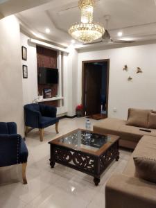 a living room with a couch and a coffee table at Tranquil apartments in Islamabad